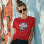 Woman wearing Chill Vibes sloth t-shirt leaning on a wall with sunglasses and messy bun
